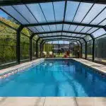 What Are the Pros and Cons of Glass vs. Polycarbonate for Pool Enclosures?